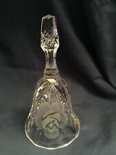 clear glass bell . Etched rose. Label can't be read.  Shield shape. 