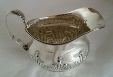 A Victorian sterling silver cream jug. London 1899.By William Hutton & Sons Ltd