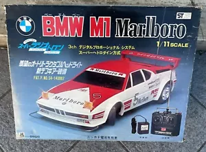 BMW M1- 1/11- RADIO TRON K.K. MATSUSHIRO RC MARLBORO-NIKI LAUDA 1980 NEW-VINTAGE - Picture 1 of 9