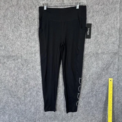 Leggings deportivos Bebe para mujer medianos negros plateados estrás logotipo bolsillos elásticos Foto 1 de 4