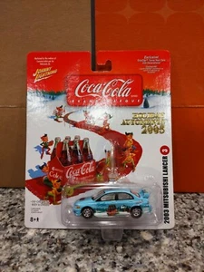 Johnny Lightning Coca-cola 2005 MITSUBISHI LANCER HOLIDAY AUTOMENTS 2005 NIP - Picture 1 of 6