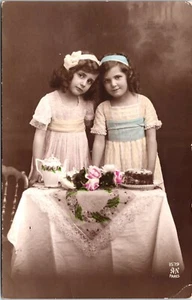 PORTRAIT OF TWO ADORABLE GIRLS : HAVING TEA AND CAKE : ALFRED NOYER : (1916) - Picture 1 of 3