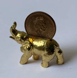 MINIATURE GOLD TONE METAL ELEPHANT FIGURE WITH 1997 CANADIAN ONE CENT COIN - Picture 1 of 5