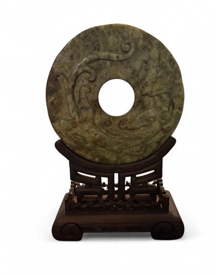 Disco bi de jade verde espinaca sobre soporte de madera dura protección y armonía de jade chino Foto 1 de 4