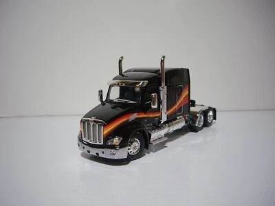 DCP FIRST GEAR 1/64 BLACK WITH WAVE PETERBILT 579 WITH 72" MID-ROOF SLEEPER - Image 1 of 4