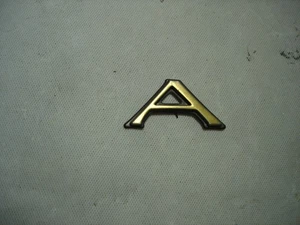1998-2002 CADILLAC ELDORADO GOLD LOWER DOOR TRIM MOLDING SCRIPT LETTER A - Picture 1 of 3
