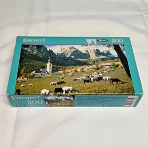 RoseArt Encore 500 Piece Puzzle AMAZING GRAZE Goats Grazing Church Mountain View - Picture 1 of 9