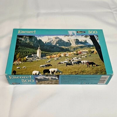 RoseArt Encore 500 Piece Puzzle AMAZING GRAZE Goats Grazing Church Mountain View - Image 1 of 4