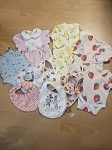 NEWBORN GIRL'S BUNDLE, 2 BODY SUITS, 2 ROMPER SUITS, 5 BIBS, NEVER WORN OR USED - Picture 1 of 4