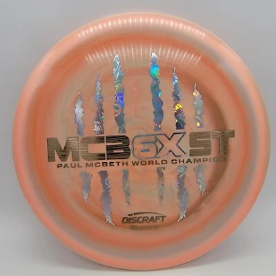 Discraft Buzzz Paul McBeth 6X McBeast Peach Swirl/Wood Grain-Money 175-176g - Image 1 of 3