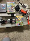 nes console with games and zapper