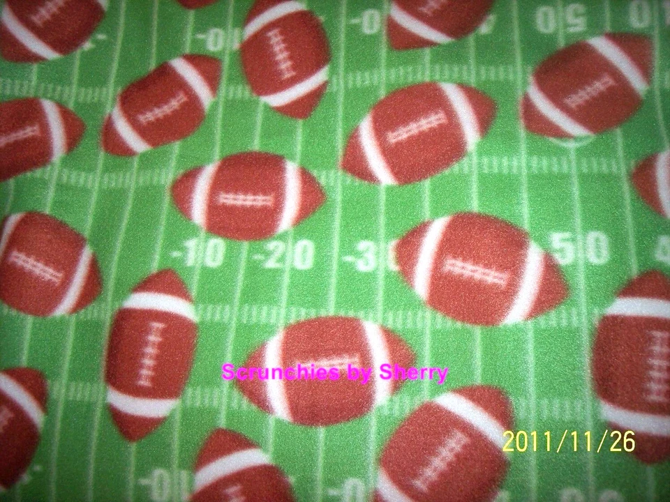 Football on Green Field Fleece Craft Sewing Fabric by the Yard NEW - Image 1 of 1