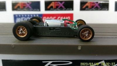 AFX RACING H.O. ESCALA MEGA G+ 1.5 CHASIS ESTRECHO LLANTAS DORADAS GIROS PLATEADOS CÁMARA ROJA Foto 1 de 4