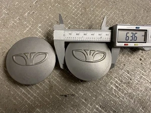 2x Daewoo 63mm wheel centre caps . M100 # JL747 - Picture 1 of 2