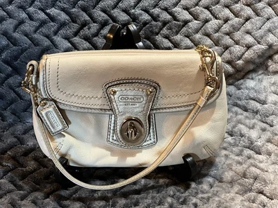 Muñequera/bolso de mano/hombro Coach crema y dorado con bloqueo giratorio.  Foto 1 de 4