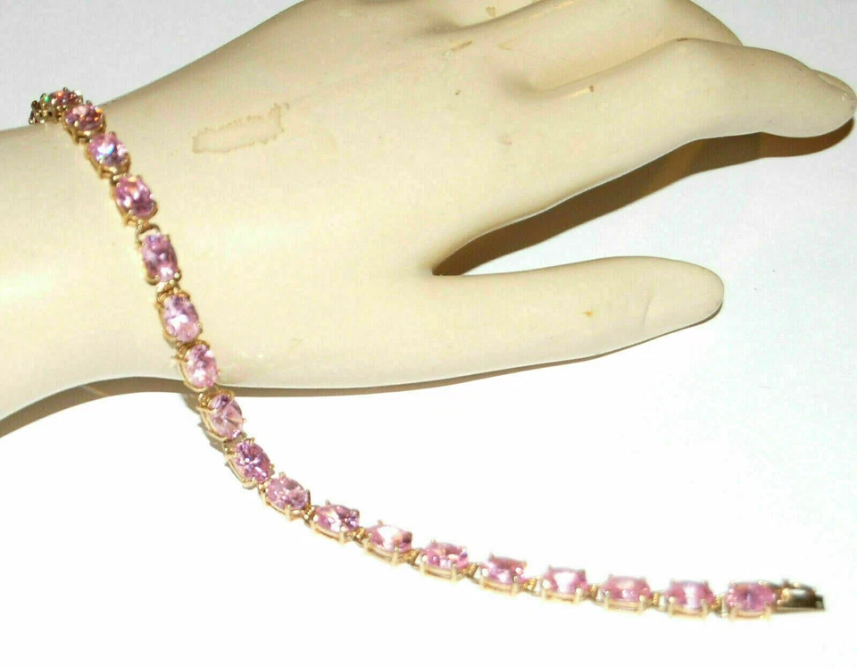 Brazalete de tenis para mujer de zafiro rosa creado en laboratorio ovalado de 9 quilates acabado en oro amarillo de 14 quilates Foto 1 de 4