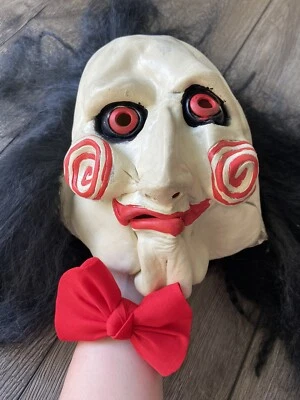 Billy the puppet mask from the Saw movie franchise, plus a red bow tie to match - Image 1 of 4