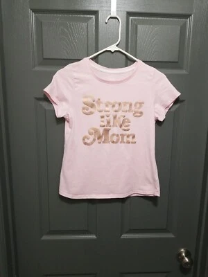 CAMISETA FUERTE COMO MAMÁ, NIÑAS XXL (18) Rosa con Letras Bronce  Foto 1 de 4