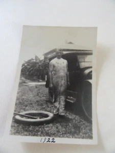 1922 B&W Photograph Of Young Man In Coveralls Changing a Tire On A Vintage Car - Picture 1 of 2