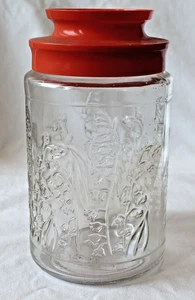 Tarro de vidrio vintage TANG Anchor Hocking Lilies of the Valley con tapa de plástico naranja - Imagen 1 de 3