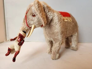 Antiguo elefante de cuerda de felpa de Japón 1940 con nativo montado en baúl - Imagen 1 de 6