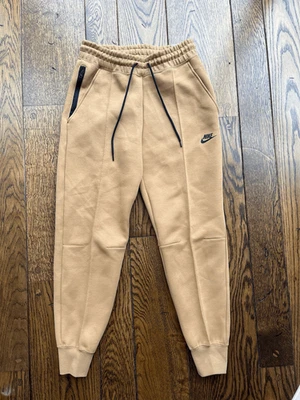 Pantalones de chándal Nike Tech polar talla pequeña para mujer tiro medio ropa deportiva lino marrón $120 Foto 1 de 4