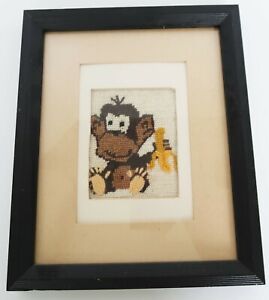 Vintage framed & matted monkey eating a banana plastic canvas needlework