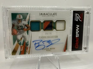 2021 IMMACULATE REGGIE BUSH GOLD ON-CARD TRI PATCH AUTO GAME-USED SP /75 HEISMAN - Picture 1 of 2