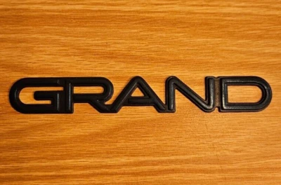 Pontiac "Grand" Am 1992-1997 emblema de puerta delantera de plástico - azul - como se quitó Foto 1 de 4