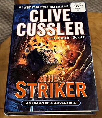 The Striker By Clive Cussler & Justin Scott HCDJ 1st/1st 2013 An Isaac Bell Adv. - Image 1 of 4