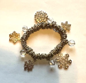 Snowflake and Clear Beads Stretch Bracelet with Oval Goldtone Cluster of Circles - Picture 1 of 3