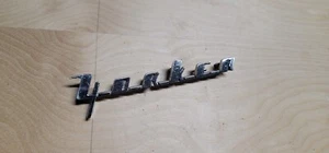 1956 Chrysler New Yorker Fender Emblem Badge Chrome Trim Molding Script - Picture 1 of 3