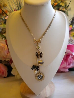 BETSEY JOHNSON BLACK AND WHITE POLKA DOT LUCITE AND CRYSTAL MULTICHARM NECKLACE - Image 1 of 4