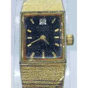 Bulova women's dress watch. Black square face with gold accents