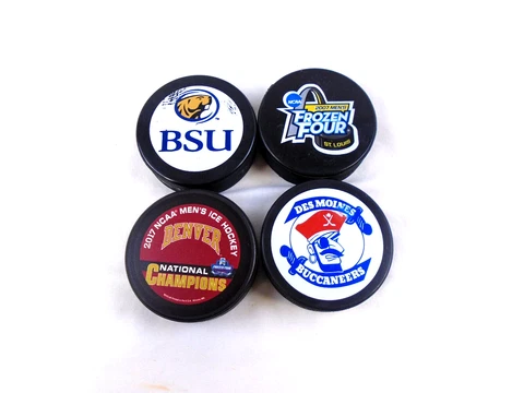 Four NCAA USHL Collectible Hockey Pucks Cover