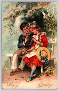 A378 Vintage Postkarte geprägt liebevolle Grußkarte Paar auf Bank Blumen Hut - Bild 1 von 2