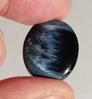 Pietersite bleu nuit effet chatoyant en cabochon ovale de 20.42Cts