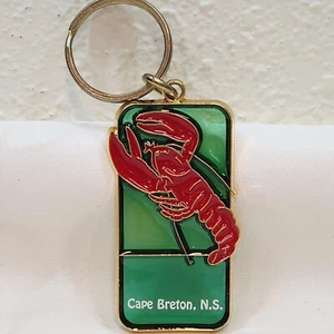 Vintage Cape Breton NS Karabiner Schlüsselanhänger grün durchscheinend Goldrand Kanada - Bild 1 von 1