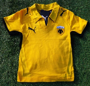 AEK Atenas Baby Home Shirt talla 62 Puma NUEVO amarillo negro D38939-041 Greece - Imagen 1 de 4