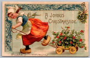 Christmas Postcard Dutch Girl Wooden Shoes Pulling Cart Ellen Clapsaddle Signed - Picture 1 of 5