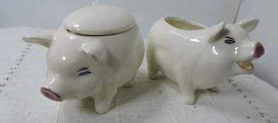 Ceramic creamer and sugar both are pigs sugar has lid and spoon - Image 1 of 4