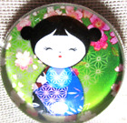 GLASS DOME PIC BUTTON - JAPANESE KOKESHI DOLL IN BLUE W GREEN BKG & PINK FLOWERS