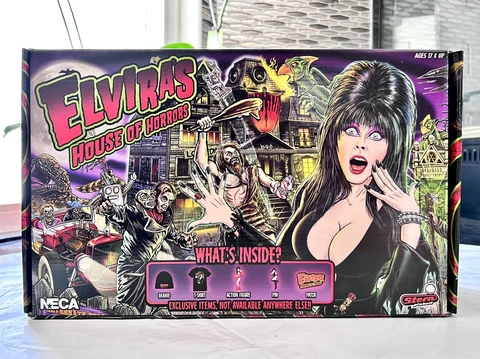 Neca Elvira’s House Of Horrors Set (Includes Beanie, Shirt, Figure, Pin & Patch) Cover