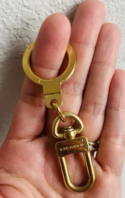 Porta llaves y extensor de correa Louis Vuitton Goldtone Bolt Foto 1 de 4