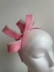 Pink and white loop fascinator with white netting on a headband. - Picture 1 of 5