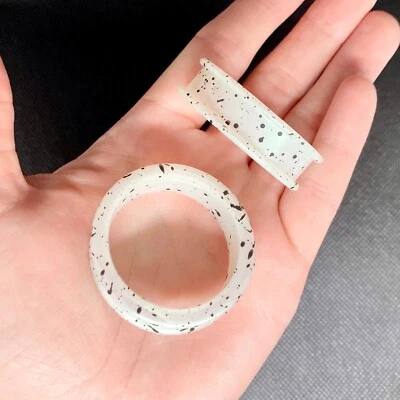 Túneles de doble llamarada de silicona con salpicaduras negras iridiscentes 8 g - 1" Foto 1 de 2