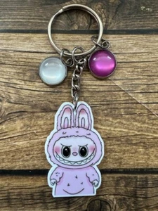 Mochila Llavero Monstruo Lavanda Púrpura Etiqueta Cremallera Tirar Ojo de Gato Cartera Dije - Imagen 1 de 1