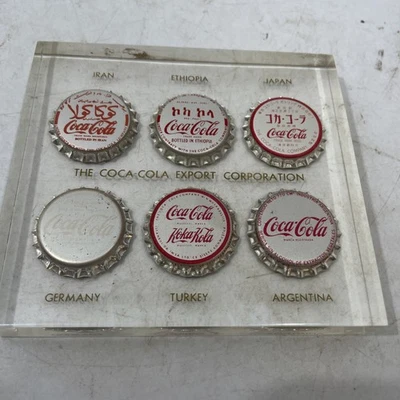 Pisapapeles transparente Coca-Cola Export Corporation 6 tapas de botellas de Coca-Cola International Foto 1 de 4