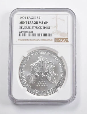 Mint Error MS69 1991 American Silver Eagle REV Struck Thru NGC *3455 - Image 1 of 3
