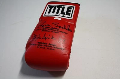 MICHAEL SPINKS & LEON SPINKS DUAL SIGNED TITLE RED BOXING GLOVE JSA WITNESS   - Image 1 of 3